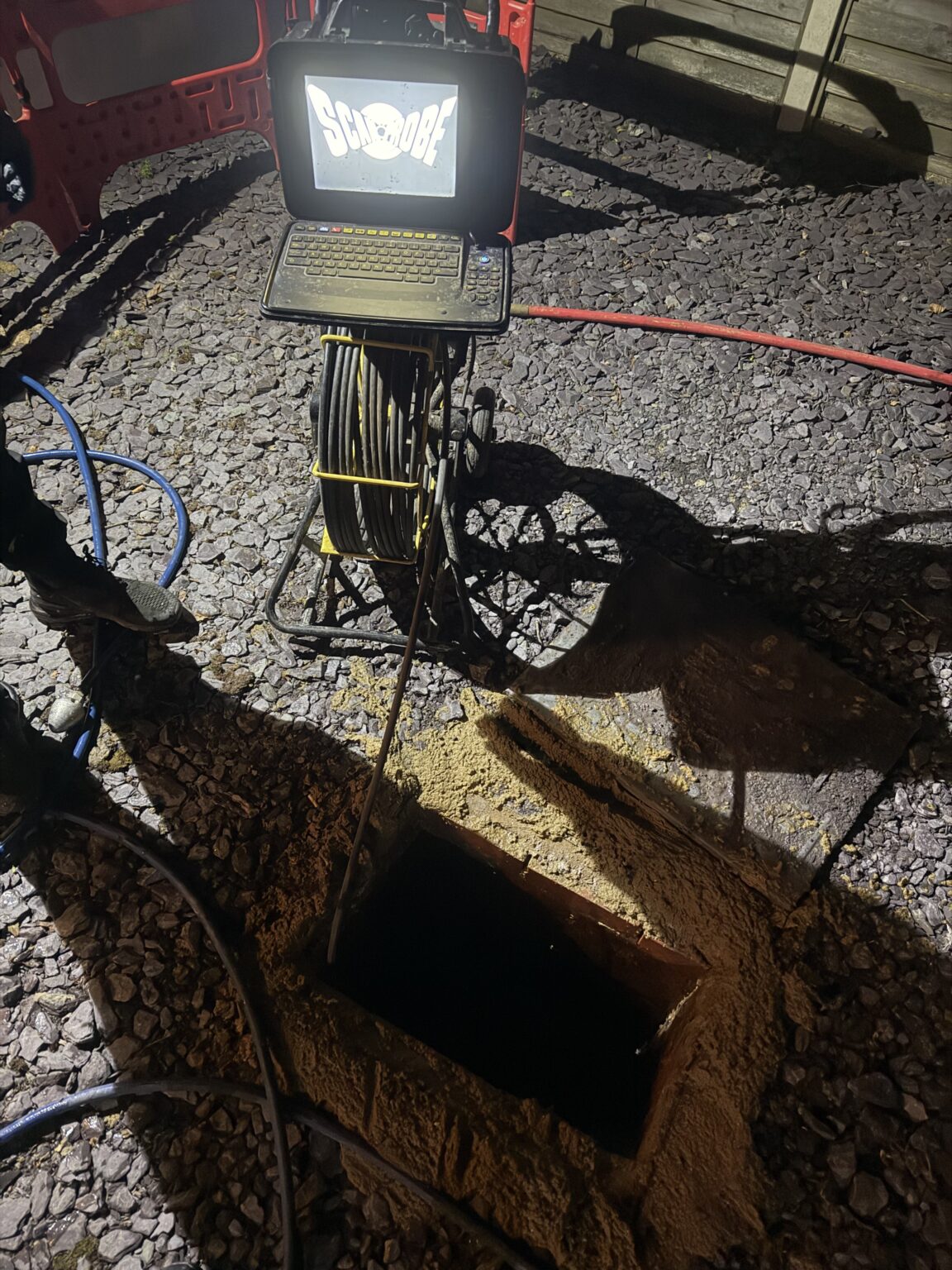 CCTV drain survey camera unit on stand with monitor and cable reel — drainage inspection
