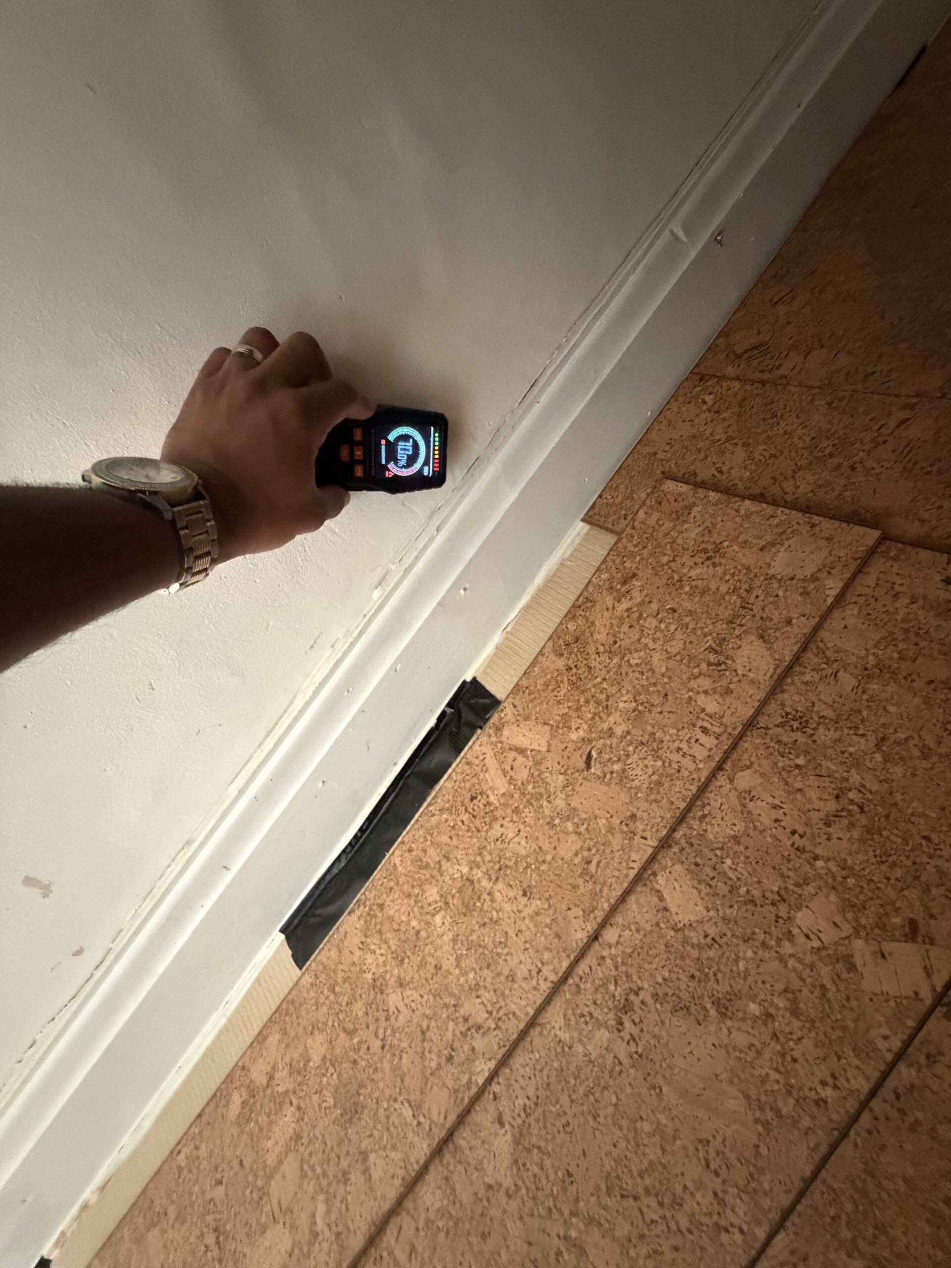 Moisture meter reading 71.5% on damp wall at skirting board — damp proofing survey